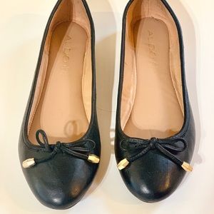 Aldo black bow-tie flats with gold colored accents